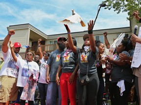 Doves are released after minutes of silence during a memorial ceremony for Michael Brown on Canfield Drive in Ferguson, Mo., Tuesday, Aug. 9, 2016. Brown's death "opened the eyes of the world" to concerns about law enforcement's treatment of black people, his father said Tuesday during a memorial service marking the two-year anniversary of the shooting. (David Carson/St. Louis Post-Dispatch via AP)