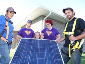Liberty Shawana, left, of Enviro Energy, and Travis Tessier, right, of Roberts Electrical, show a solar panel to the Jewers family members which includes Lee, Kylee, 7, and Josee, at the family home in Chelmsford, Ont. on Tuesday August 9, 2016. The Jewers received a donation of a 10 kilowatt solar power system. Super Kylee Jewers and her family received the donation because of Kylee's battle with cancer. She was only five years old when her family discovered that she has a serious and rare form of sarcoma cancer. The Super Kylee Solar Project was made possible thanks to Dixon Electric, Enviro Energy, Home Energy Solutions, Independent Electrical System Operator, Manitoulin Transport and Roberts Electrical. A press release issued by Enviro Energy said