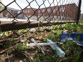 Parts of a drug kits are seen in the grass beside St. Mary's Catholic School on Aug. 9, 2016 which is close to a legal injection sight opening at the community centre across the street. (Craig Robertson/Toronto Sun)