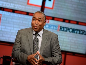 In this May 12, 2013 photo John Saunders poses on the set of "The Sports Reporters" in Studio A in Bristol, Conn. Saunders, who has hosted "The Sports Reporters" for the last 15 years, has died, the ESPN announced Wednesday, Aug. 10, 2016. He was 61. (Joe Faraoni/ESPN Images via AP)