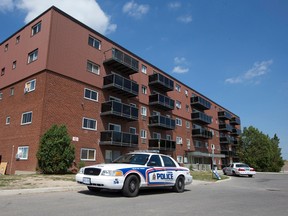 Police cruisers are seen parked outside an apartment building at 1 Frontenac Road, behind which the body of a deceased man in his fifties was found shortly before 7 a.m., in London, Ont. on Wednesday August 10, 2016. Police are investigating the death.  (CRAIG GLOVER, The London Free Press)