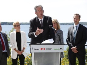 (From left) Michael Gravelle, Ontario Minister of Northern Development and Mines, Ontario Premier Kathleen Wynne, Cathy Cox, Manitoba Minister of Sustainable Development and Matthew McCandless, Executive Director of International Institute for Sustainable Development listen in as Manitoba Premier Brian Pallister speaks at a $1.7 million federal investment into the IISD Experimental Lakes Area on the shore of Lake of The Woods in Kenora, Wednesday, August 10, 2016. IISD Experimental Lakes Area is a research facility where scientists conduct research on lakes and ecosystems.