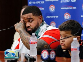 Texas Rangers’ Prince Fielder, left, wipes his eyes as he sits by his son Haven during a news conference Wednesday Aug. 10, 2016, in Arlington, Tex. (AP Photo/Tony Gutierrez)
