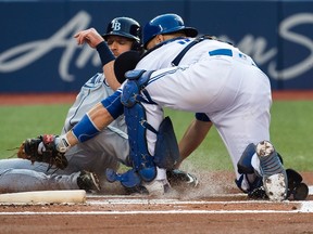 Toronto Blue Jays catcher Russell Martin (55) tags out Tampa Bay Rays second baseman Logan Forsythe (11) at home plate at the Rogers Centre Wednesday, August 10, 2016. (THE CANADIAN PRESS/Nathan Denette)