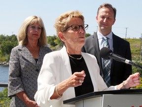 Ontario Premier Kathleen Wynne addresses a gathering in Kenora on Aug. 10, 2016. Wynne is joined by Manitoba MLA Cathy Cox and Matt McCandless, executive director of the International Institute for Sustainable Development Experimental Lakes Area. (Sheri Lamb/Postmedia Network)