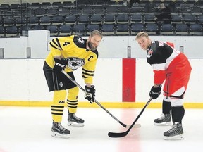 Birkir Arnasson, left, the 6'8” captain of the Skautafelag Björninn team of Iceland, poses in faceoff position with 6'3” Aidan Wiebenga of the Tilbury Selects.