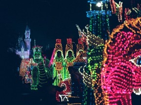 In this Nov. 25, 1996, file photo, the Main Street Electrical Parade moves down Main Street in Disneyland, in Anaheim, Calif., during its last night of performances. Disney says the parade will return to Disneyland for a limited run after it ends its run at Walt Disney World in Florida on October 9th. (AP Photo/Frank Wiese, File)