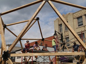 A crew takes a break from assembling a geodesic dome on Durham Street in Sudbury, Ont. on Wednesday August 10, 2016 for Up Here. The doom will be the main entrance to the venue on Durham Street. The festival, which runs from Aug. 11-14, will feature music and art. John Lappa/Sudbury Star/Postmedia Network
