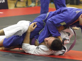 Cameron Florczak (blue gi) of Team Renzo Gracie OAMA in Ottawa works from top position against David Krimus of Toronto BJJ during the 2015 Budo Open Brazilian jiu-jitsu tournament at Cambrian College last year. The same event will be contested this weekend. Ben Leeson/The Sudbury Star/Postmedia Network
