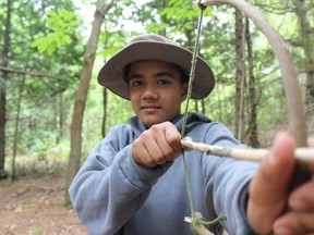 Samantha Reed/The Intelligencer
Thirteen-year-old cadet Kenneth Lagmay shows off a bow and arrow he made out of sticks and rope during the construct camp crafts lesson at the Macaulay Mountain Conservation Area in Picton.