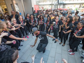 Staff of H&M entertain large lines of people waiting to get into the store during the grand opening of the Rideau Centre expansion ahead of the 10:15am opening.