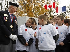 File photo by Chris Wattie/REUTERS
School children look at Canadian Second World War veteran Phil Etter's medals following a Remembrance Ceremony at the Le Quesnel Memorial in Le Quesnel, France November 10, 2008. Mr. Etter died Aug. 6.