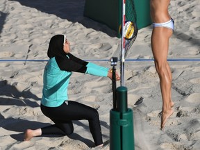 Egypt's Doaa Elghobashy controls the ball in front of Canada's Kristina Valjas during the women's beach volleyball qualifying match between Canada and Egypt at the Beach Volley Arena in Rio de Janeiro on August 11, 2016, for the Rio 2016 Olympic Games. (Yasuyoshi Chiba/AFP/Getty Images)