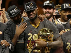 Cleveland Cavaliers forward LeBron James (middle) celebrates with teammates after Game 7 of the NBA Finals against the Golden State Warriors in Oakland, Calif., Sunday, June 19, 2016. (AP Photo/Marcio Jose Sanchez)