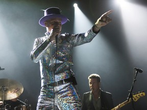 Gord Downie, center, and Gord Sinclair of The Tragically Hip perform on Wednesday, Aug. 10, 2016, in Toronto, Canada. (Photo by Arthur Mola/Invision/AP)