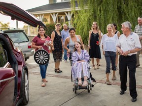 This July 24, 2016 photo provided by Niels Alpert, Betsy Davis, center, is accompanied by friends and family for her first ride in a friends new Tesla to a hillside to end her life during a "Right To Die Party" in Ojai, Calif. (Niels Alpert via AP)