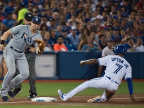 Toronto Blue Jays left fielder Melvin Upton Jr. steals third base past Tampa Bay Rays third baseman Evan Longoria on August 10, 2016. (NATHAN DENETTE/The Canadian Press)