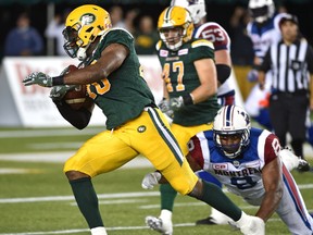 Edmonton Eskimos Deon Lacey (40) makes an interception and runs for a TD with under one minute left to play as Montreal Alouettes Nik Lewis (8) makes a diving effort during CFL action at Commonwealth Stadium in Edmonton Friday, August 11, 2016.