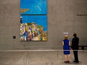 Guests view an oil painting titled 'Looking South' at the National September 11 Memorial and Museum, August 3, 2016 in New York City. The large-scale oil painting by Daniel Kohn, donated by Fiduciary Trust, shows the pre-9/11 views from the South Tower of the World Trade Center. (Photo by Drew Angerer/Getty Images)