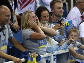 Sweden's Sarah Sjostrom's parents, Goran (L) and Jenny Sjostrom (2ndL) celebrate after their daughter broke the World Record in the Women's 100m Butterfly Final during the swimming event at the Rio 2016 Olympic Games at the Olympic Aquatics Stadium in Rio de Janeiro on August 7, 2016. Odd AndersenODD ANDERSEN/AFP/Getty Images