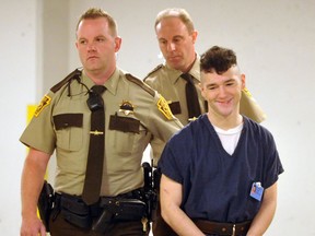 In this photo taken May 14, 2015, Caleb Barnes, 21, is escorted to court for a  preliminary hearing in Allentown, Pa.  Jamie Silvonek, accused of plotting with her boyfriend 21-year-old Army Spc. Caleb Barnes via text to kill her mother, pleaded guilty Thursday, Feb. 11, 2016, in a deal with prosecutors. As part of the deal, Silvonek pleaded guilty to first-degree murder, criminal conspiracy, abuse of a corpse and tampering with evidence. She will be eligible for parole after serving 35 years. Barnes's trial is set for April 11. (Bill Adams/The Express-Times via AP)