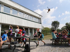 Emily Mountney-Lessard/The Intelligencer
A Search and Rescue helicopter from 8 Wing's 424 Transport and Rescue Squadron arrives for a visit with some day campers at Batawa Ski Hill on Friday.