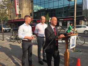 Councillors Joe Cressy and  Mike Layton listen as Ashley Curtis, of Toronto's transportation department, talks about the studies planned for the Bloor St. bike lanes. (MARYAM SHAH, Toronto Sun)