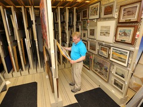 David Huff, curator of collections at the Tom Thomson Art Gallery, in the gallery's art storage vault in the basement of the gallery on Wednesday, June 29, 2016 in Owen Sound, Ont. The gallery plans to expand into a $10.5-million, 35,000-square-foot visual arts centre. (James Masters/The Owen Sound Sun Times)