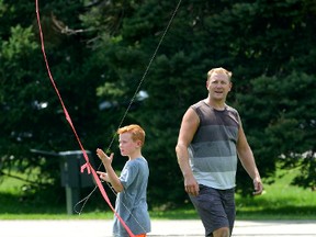 Liam Williams, 10, visiting from Toronto, enjoys the weather Friday by flying a kite with his father, Mike Williams, in London?s Victoria Park. If you?re hoping for vivid fall colours this autumn, you might as well just go fly a kite. (MORRIS LAMONT, The London Free Press)