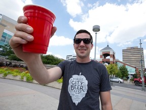 Forest City Beer Fest founder and organizer Aaron Brown raises a glass to the craft-brew-centric event which takes place this Saturday in Golden Jubilee Square and the Covent Garden Market in London, Ont. on Wednesday August 10, 2016. (CRAIG GLOVER, The London Free Press)