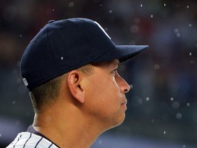 Alex Rodriguez of the New York Yankees watches a video presentation in his honor, as rain falls before the game against the Tampa Bay Rays at Yankee Stadium on August 12, 2016 in New York City. (Photo by Drew Hallowell/Getty Images)