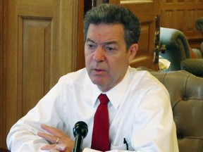 ansas Gov. Sam Brownback answers questions from reporters during a news conference in his Statehouse office, Friday, Aug. 12, 2016, in Topeka, Kan.. Brownback says he wants the state to review its regulation of amusement park rides following the death of a 10-year-old state lawmaker's son on a Kansas City, Kan., waterslide (AP Photo/John Hanna)