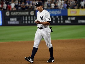 New York Yankees' Alex Rodriguez walks towards third base with the game ball after the Yankees defeated the Tampa Bay Rays 6-3 in Rodriguez's final game as a Yankee player, Friday, Aug. 12, 2016, in New York. (AP Photo/Adam Hunger)