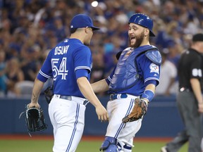 Russell Martin of the Toronto Blue Jays celebrates their victory with Roberto Osuna during MLB game action against the Houston Astros on August 13, 2016 at Rogers Centre in Toronto, Ontario, Canada. (Photo by Tom Szczerbowski/Getty Images)