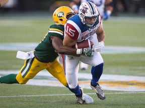 Montreal Alouettes' Samuel Giguere (15) is tackled by Edmonton Eskimos' Kenny Ladler (37) during first half CFL action in Edmonton on Thursday, August 11, 2016.