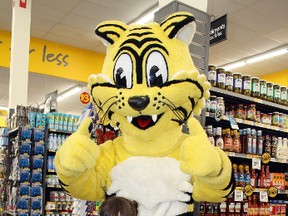 Leigha St. Germain poses with Friendly the Giant Tiger during grand-opening celebrations at the new Giant Tiger Store in the Southridge Mall on Saturday. Ben Leeson/The Sudbury Star/Postmedia Network
