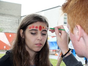 Sara Tower has her face painted by Liam Barsey during the Up Here festival in downtown Sudbury in 2016. Ben Leeson/The Sudbury Star/Postmedia Network