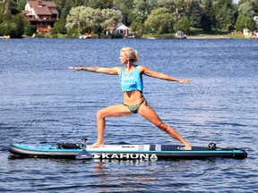 Gino Donato/Sudbury Star 
Meghan Juuti, CEO and producer of SUP Yoga Sudbury, demonstrates a asana (a yoga pose) on Lake Nepahwin in Sudbury.