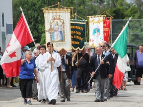 Filomena Gabriele with the San Rocco Festival organizing committee in Sarnia, directs a traditional procession at the weekend celebration. The festival has been held in Sarnia since 1972. Tyler Kula/Sarnia Observer/Postmedia Network