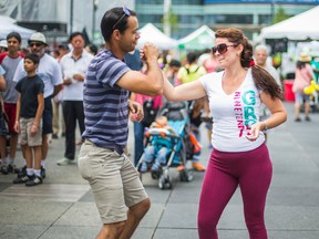 Dayana and her husband, Elier Riveron, enjoy the music from the main stage at the Pan American Food Festival at Yonge-Dundas Square on Sunday. (ERNEST DOROSZUK, Toronto Sun)