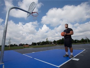 Ferras Hayek, who won a $25,000 prize from Kraft Canada last summer to upgrade a pair of basketball courts in London?s White Oaks neighbourhood, plays on the newly tiled court surface behind White Oaks elementary school. (CRAIG GLOVER, The London Free Press)