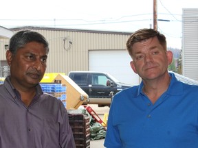 Wildrose Leader Brian Jean and Prasad Panda, Wildrose MLA for Calgary-Foothills, listen to a volunteer speak at the Wood Buffalo Food Bank in Fort McMurray, Alta. on Saturday August 13, 2016. Vincent McDermott/Fort McMurray Today/Postmedia Network