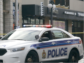 A police car sits in front of businesses on Dalhousie St. in the ByWard Market after a fatal shooting in Ottawa on Sunday, August 14, 2016. (Patrick Doyle, Postmedia)
