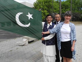 Ward 9 Coun. Deb McIntosh read a proclamation from the city at a flag-raising Sunday to mark Pakistan Independence Day. Among those at the ceremony, at Tom Davies Square, were Qazi M. Haque, president of the Pakistan Canada Cultural Society of Sudbury, left, and club founder Muhammad Javaid. (Carol Mulligan/Sudbury Star)