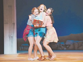 Danielle Wade, centre, plays soon-to-be-married Sophie, who ? with the help of friends played by Jade Repeta, left, and Judy Kovacs ? goes through her mother?s old diary in search of her father?s identity in Mamma Mia! at Huron Country Playhouse until Sept. 3. (Special to Postmedia News)