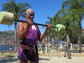 Jose Rebamar, 75, lifts weights at an outside gym in Rio de Janeiro, Brazil, Sunday, Aug. 14, 2016. With near daily sunshine and warm weather all year, the former Brazilian Navy sailor says there is no excuse to ever slow down.  “I need to stay in shape,” said Rebamar, interspersing barbell sets with Yoga-like stretches on a stone bench. “If I don’t work out one day, I feel like I didn’t do anything, like the day didn’t happen.” (AP Photo/Peter Prengaman)