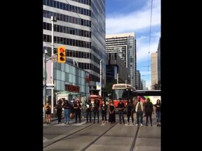 Black Lives Matter-Toronto take over the intersection of Yonge and Dundas Sts. during Monday morning rush-hour Aug. 15, 2016.