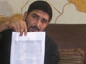 This photograph taken on July 28, 2016 shows Mukhtar Kazam, the husband of late British woman Samia Shahid, as he displays her post-mortem report during a press conference in Rawalpindi. The husband of a British woman who was killed in Pakistan has called for the UK and Pakistani governments to ensure his wife received justice, as he sought to keep the spotlight on so-called 'honour' killings.(HABIB SHAIKH/AFP/Getty Images)