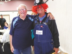 1995 Grouch John Lauer and 2016 Grouch Randy Trydal share at laugh at the Legion Hall during Pembina Valley Daze