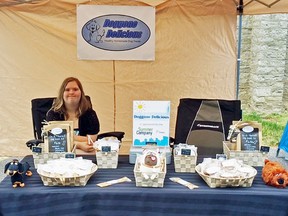 Submitted Photo
Brandi Sokil sits in her business’s booth at the Wellington Farmers’ Market. She is one of 30 local students to start their own business this summer. Sokil’s mother, Barb, is speaking out about how great the program has been for her daughter, who was born with Down Syndrome.